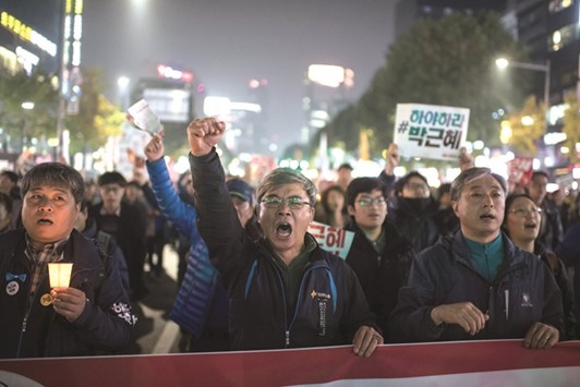 Demonstrators shout slogans during a protest calling for the resignation of South Korean President Park Geun-Hye in central Seoul yesterday.