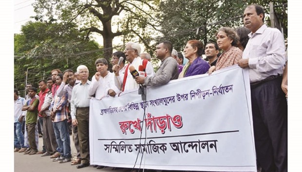 Bangladeshi religious minority people form human chains in Dhaka.
