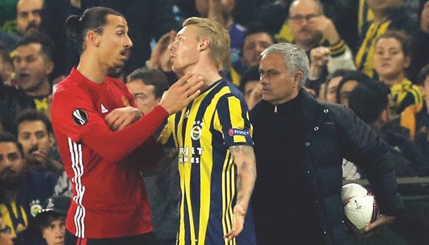 Manchester Unitedu2019s Zlatan Ibrahimovic clashes with Fenerbahceu2019s Simon Kjaer as manager Jose Mourinho looks on during their UEFA Europa League match in Istanbul. (Reuters).