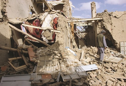 An Afghan man inspects a house destroyed during an air strike on suspected Taliban militants in Kunduz, yesterday.