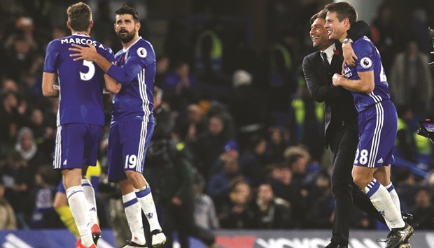 Chelsea manager Antonio Conte celebrates with Cesar Azpilicueta after the match  against Everton yesterday.