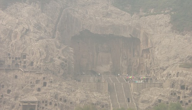 A 2006 file photo of Longmen Caves in Luoyang, Henan province. This view from across the valley is covered by a foul blanket of choking haze. Pollution in China gets worse in winter every year, and it doesnu2019t appear to be getting any better.        Photo by G41rn8/Wikipedia