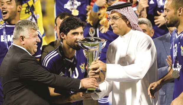 AFC chief  Sheikh Salman bin Ebrahim al-Khalifa hands over the AFC Cup trophy to the Air Force Club side.