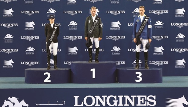 Global Champions Tour overall champion champion Rolf-Goran Bengtsson (centre) of Sweden poses on the podium with Australiau2019s Edwina Tops-Alexander (left), who came second and third-placed Christian Ahlmann of Germany after the Grand Prix of Doha at Al Shaqab arena yesterday, which was the concluding day of the three-day event. PICTURES: Jayaram