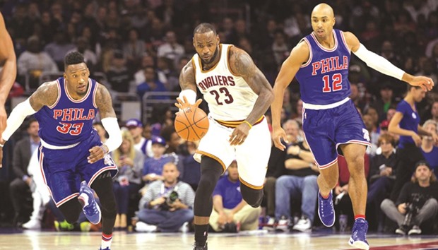 Cleveland Cavaliers forward LeBron James (No 23) dribbles past Philadelphia 76ers guard Gerald Henderson (No 12) and forward Robert Covington (No 33) during the second quarter at Wells Fargo Center. PICTURE: USA TODAY Sports