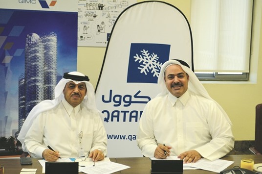 Al-Ansari (left) with al-Jaidah during the agreement signing.