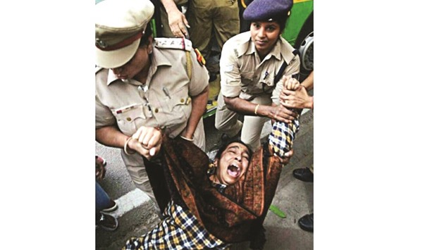 Policewomen take away missing JNU student Najeeb Ahmadu2019s mother, Fatima during a protest near India Gate yesterday.
