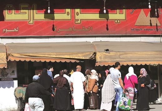 Egyptians gather to buy subsidised goods from a government market, after goods shortage in retail stores across the country and after the central bank floated the pound currency, in downtown Cairo yesterday.