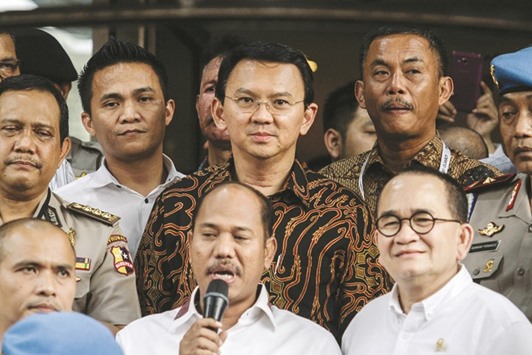 Governor Basuki Tjahaja Purnama (second row, centre), known by his nickname Ahok, is asked questions by journalists at the police headquarters in Jakarta yesterday.