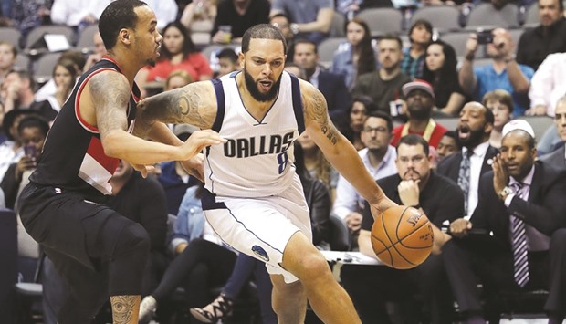 Deron Williams of the Dallas Mavericks dribbles the ball past Shabazz Napier of the Portland Trail Blazers in the second half at American Airlines Center in Dallas. (AFP)