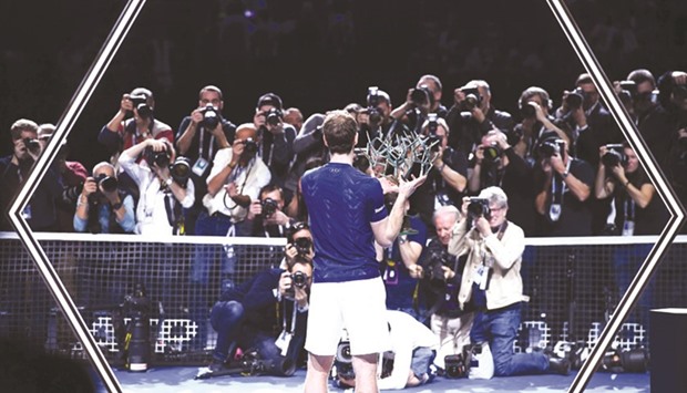 Britainu2019s Andy Murray poses with the winneru2019s trophy after beating USAu2019s John Isner in the Paris Masters final on Sunday. (AFP)