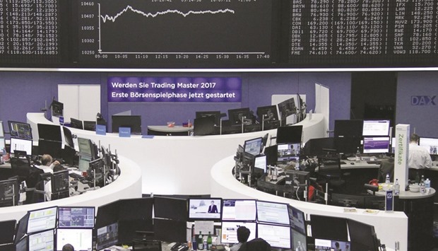 Traders work at the Frankfurt Stock Exchange. The DAX 30 rose 1.9% to 10,456.95 yesterday.