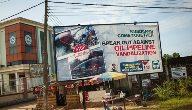 This file photo taken on June 10, 2016 shows an advertising board concerning the oil pipeline vandalization in the City of Warri in Delta State