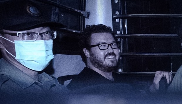 This file photo taken on November 10, 2014 shows British banker Rurik Jutting smiling as he sits in a prison van leaving the eastern court in Hong Kong. AFP