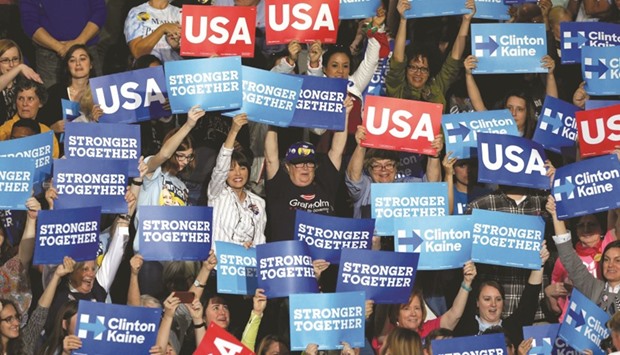 Supporters of US Democratic presidential nominee Hillary Clinton cheering while waiting for her to arrive at the Grand Valley State University Fieldhouse in Allendale, Michigan, yesterday.