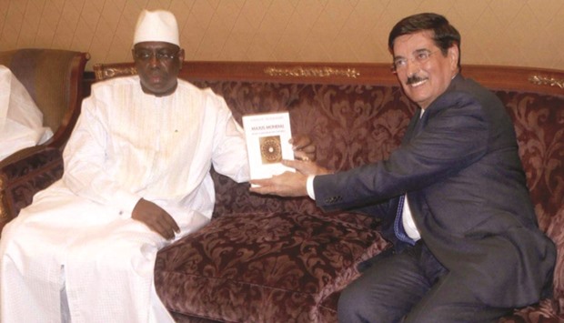 HE Dr Hamad bin Abdulaziz al-Kuwari presenting his book Global Majlis to President Macky Sall of Senegal.