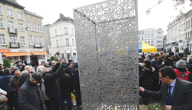 People look at the Flamme de lu2019espoir (Flame of Hope) artwork after officials unveiled the sculpture in Brusselsu2019 Molenbeek. The Flamme de lu2019espoir was unveiled in remembrance of the victims of the attacks on November 13, 2015 in Paris and on March 22, 2016 in Brussels.