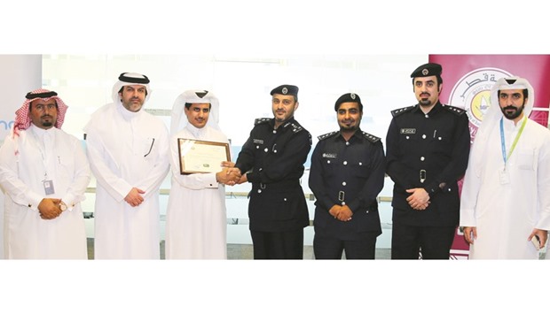 MoI, MoTC and Mada officials with the award.