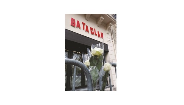 Whites roses are seen in front of the new facade of the Bataclan concert hall, almost one year after a series of attacks at several sites in Paris.
