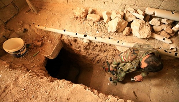 Peshmerga forces inspects a tunnel used by Islamic State militants