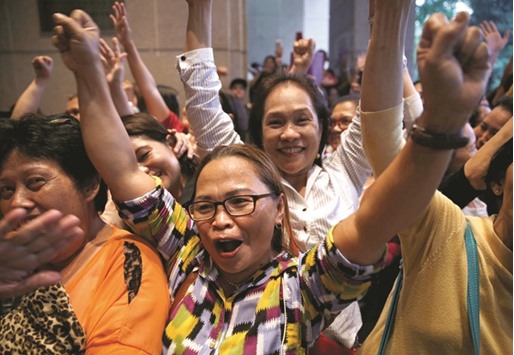 Members of the Filipino community chant slogans as they wait for the arrival of Philippines President Rodrigo Duterte during his official visit in Kuala Lumpur yesterday.