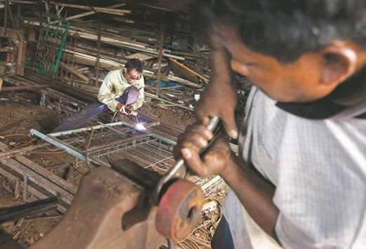 An Indonesian man welds a gate at a small metals shop in Jakarta (file). Indonesia, the worldu2019s most populous Muslim country, is looking to improve the financial inclusion of the large number of unbanked citizens as well as communities.