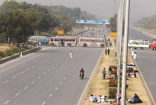 Buses block a highway to Islamabad as members of the Tehreek-e-Labaik Pakistan hold a sit-in in Rawalpindi yesterday.