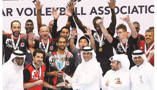 Qatar Volleyball Association (QVA) president Ali Ghanim al-Kuwari presents the winnersu2019 trophy to Al Rayyan after they won the Super Cup title at the QVA Indoor Hall yesterday. PICTURES: Jayaram