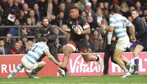 Englandu2019s Nathan Hughes runs in to score their first try during the rugby union match against Argentina at Twickenham Stadium in London yesterday. (Reuters)