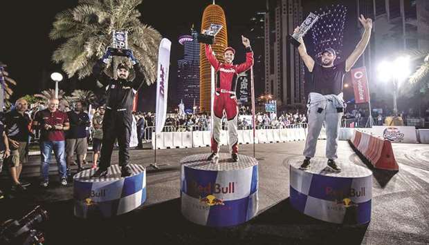 Winner Abdulrahman Fakhro (centre) celebrates with second placed Ahmad Abu Irshaid and third placed Mohamed al-Khayat on the podium of Qatar round of the Red Bull Car Park Drift.