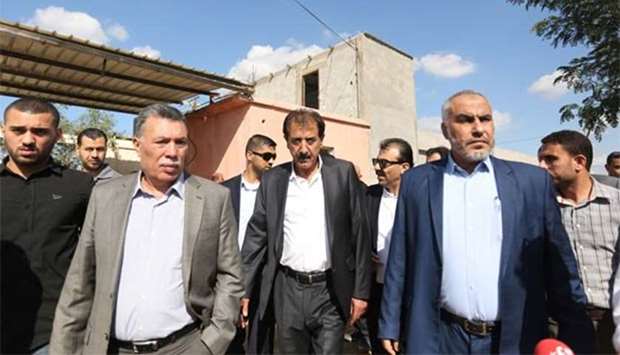 Chairman of the Palestinian Crossing Authority Nazmi Mhana (centre) walks alongside Hamas leader Ghazi Hamad at the northern entrance of the Gaza Strip just after the Israeli-controlled Erez crossing, in Beit Hanun on Wednesday.