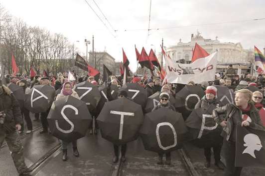 Participants hold umbrellas with letters making up u2018Stop Fascismu2019 as they take part in a rally in Warsaw, organised by Antifascist Coalition (Antifa), to mark the 99th anniversary of Polish independence.