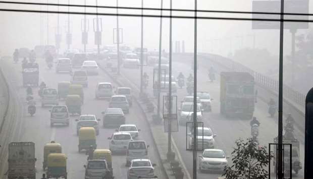 Traffic drives through heavy smog in Delhi