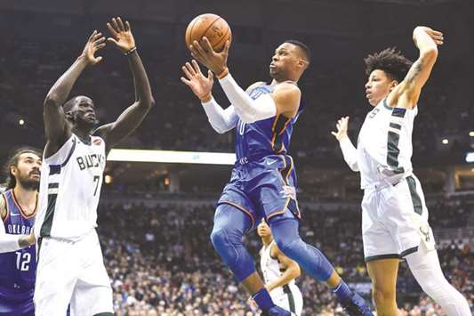 Oklahoma City Thunder guard Russell Westbrook (0) takes a shot between Milwaukee Bucks center Thon Maker (7) and forward D.J. Wilson (5) in the second quarter at BMO Harris Bradley Center. PICTURE: Benny Sieu-USA TODAY Sports