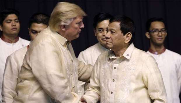 President Donald Trump greets Philippines President Rodrigo Duterte during the gala dinner marking Asean's 50th anniversary in Manila on Sunday.