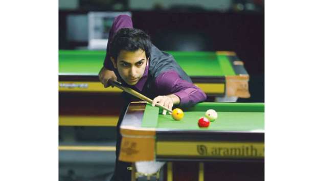 Indiau2019s Pankaj Advani lines up a shot during his world billiards final against Mike Russell of England at the Al Arabi Sports Club yesterday. (Left) Russell ponders his next move. Picture: Ram Chand