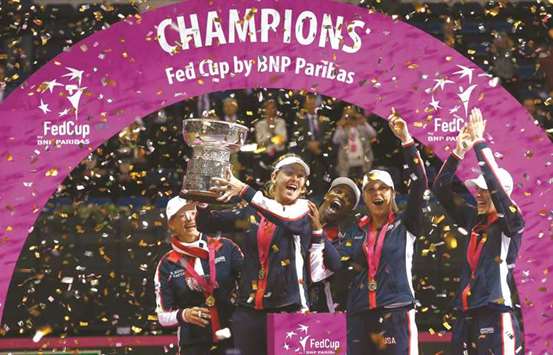 US team players celebrate with the trophy after winning the Fed Cup in Minsk, Belarus, yesterday. (Reuters)
