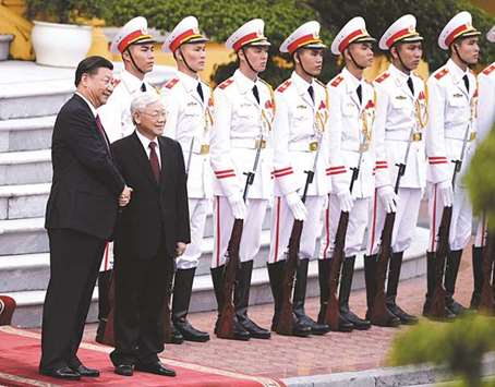 Chinau2019s President Xi Jinping (left) and Vietnamu2019s Communist Party Secretary-General Nguyen Phu Trong pose for a photo during a welcoming ceremony at the Presidential Palace in Hanoi.