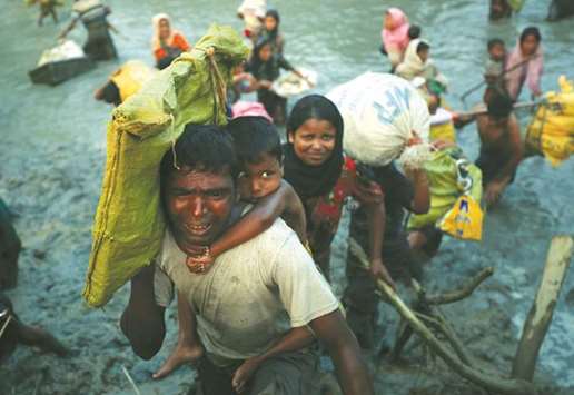 Rohingya refugees  cross the Myanmar-Bangladesh border in Palong Khali, near Coxu2019s Bazar, Bangladesh.