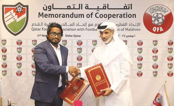 QFA president Sheikh Hamad bin Khalifa bin Ahmed al-Thani (right) with Football Association of Maldives president Bassam Adeel Jaleel.