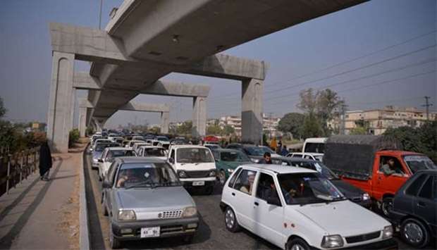 Pakistani commuters sit in a traffic jam near a highway blocked by activists of a religious group in Islamabad on Monday.