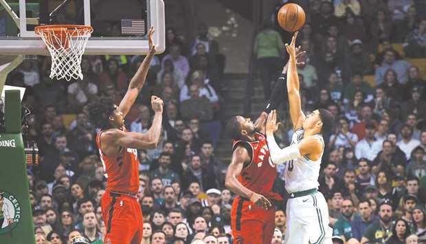 Boston Celtics forward Jayson Tatum (right) shoots the ball over Toronto Raptors forward CJ Miles during the second half at TD Garden. PICTURE: USA TODAY Sports