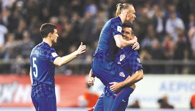 Croatian players Domagoj Vida and Dejan Lovren celebrate their qualification for the 2018 World Cup after a playing out a draw with Greece at the Karaiskakis Stadium, Piraeus in Greece on Sunday night.  Croatia qualified on 4-1 win on aggregate. (Reuters)