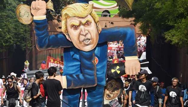 Protesters gather around an effigy of US President Donald Trump prior to a march to ASEAN Summit ven