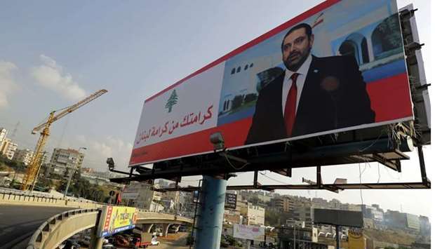 A poster of Lebanese Prime Minister Saad Hariri is seen on a giant billboard that reads in Arabic ,Your dignity is Lebanon's dignity, on the highway of Zouk Mosbeh, north of Beirut. AFP