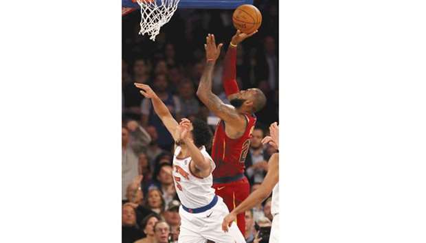 LeBron James of the Cleveland Cavaliers takes a shot over Courtney Lee of the New York Knicks in the second half their game at Madison Square Garden in New York City on Monday. The Cleveland Cavaliers defeated the New York Knicks 104-101.