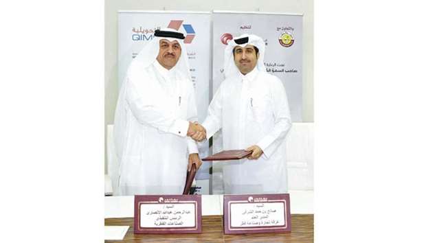 Qatar Chamber director-general Saleh bin Hamad al-Sharqi and QIMC CEO Abdul Rahman Abdulla al-Ansari shaking hands after signing the sponsorship agreement at the Chamberu2019s headquarters in Doha yesterday.