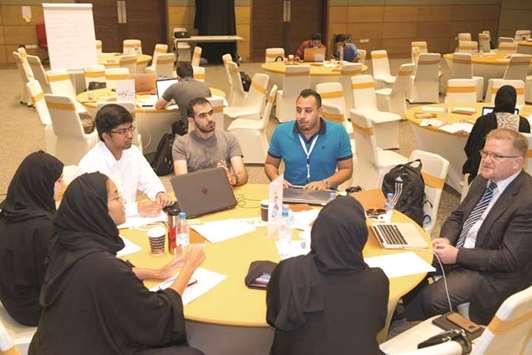 Participants of the latest u2018Startup Weekend Dohau2019 edition deliberate on a topic during the event.