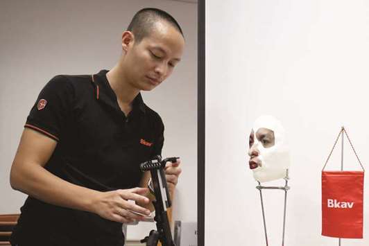 Ngo Tuan Anh, Vice President of Bkav, a Vietnamese cybersecurity firm, demonstrates iPhone X Appleu2019s face recognition ID software with a 3D mask at his office in Hanoi, Vietnam.