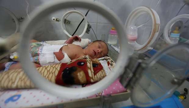 A premature baby lies in an incubator in the child care unit of a hospital in Sanaa, Yemen